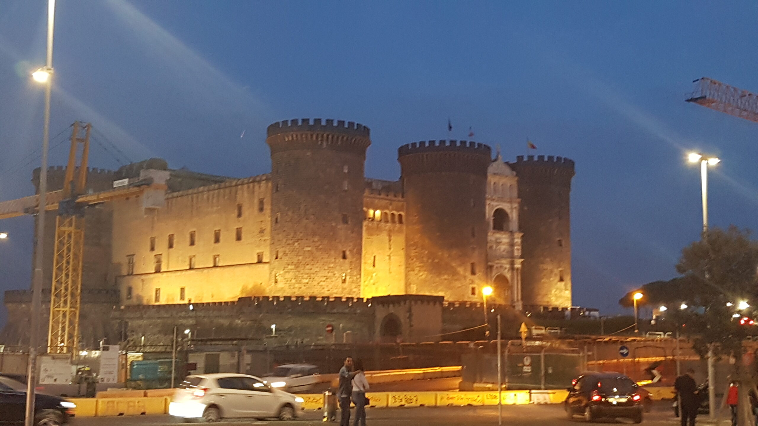 Beleuchtetes Castel Nuovo (Maschio Angioino) am Abend in Neapel